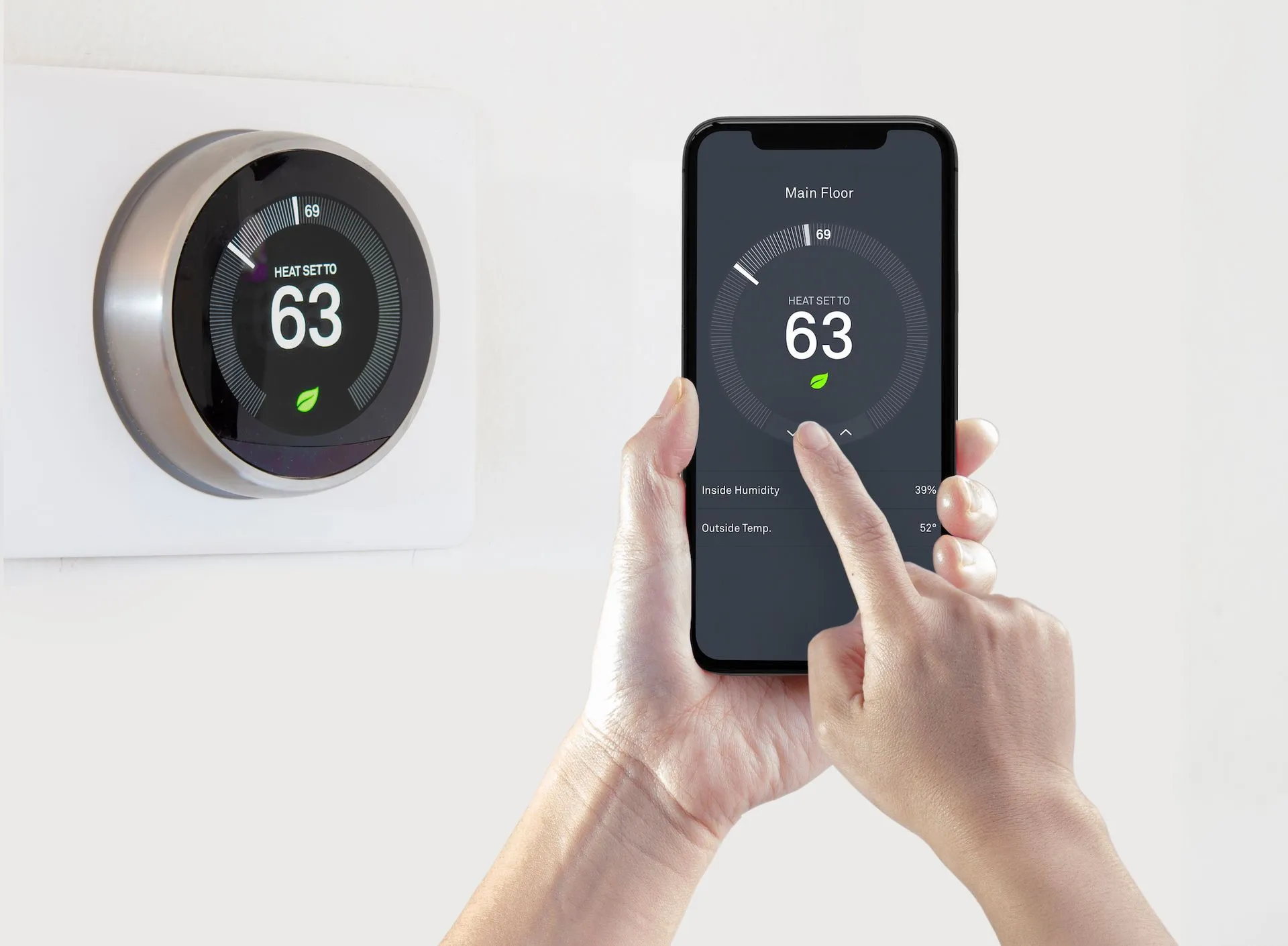 Round thermostat showing 63° beside a smartphone controlling the same temperature